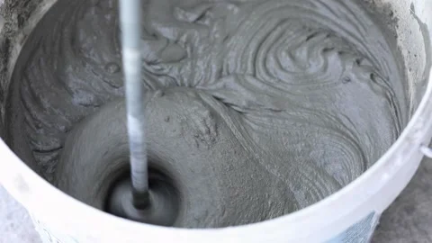 Construction mixer stirs putty in a bucket Video stock 223403437