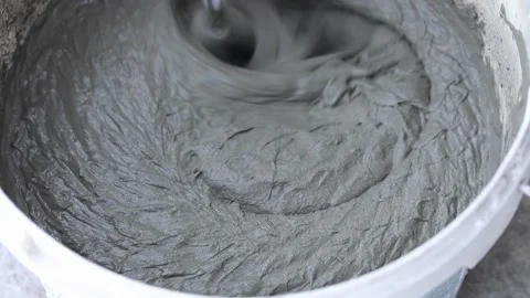 Construction mixer stirs putty in a bucket Stock Footage 224194647