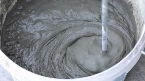 Construction mixer stirs putty in a bucket Stock Footage 228097446