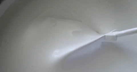 Construction mixer stirs thick white paint in bucket. Top view close-up. Home Stock Footage 291830569