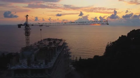 Construction of modern apartment building at sunset by sea Stock Footage 292808189