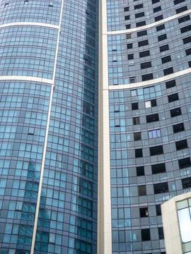 Construction of a modern multi-storey building. Glazed facade. Background f.. Stock Photos