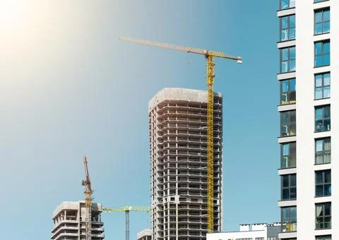 Construction of modern multi storey skyscraper with crane and scaffold. Stock Photos
