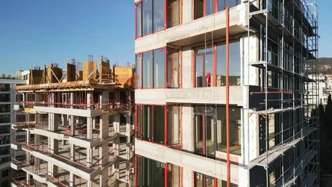 Construction of a modern multi-story building with scaffolding Stock Footage 296041992