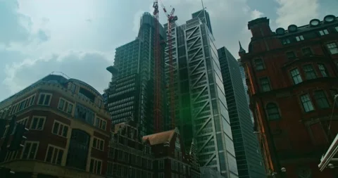 Construction of a modern office building. The work of building tower cranes Stock Footage 149875816