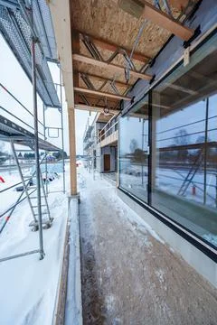 Construction of modern timber frame house in winter with scaffolding Stock Photos
