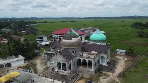 Construction of a mosque with one house not yet finished Stock Footage 142302354