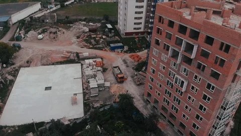 Construction of a multi-storey brick residential building of red color next to Video stock 126002258
