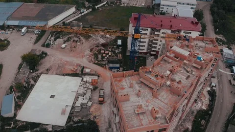 Construction of a multi-storey brick residential building of red color next to Stock Footage 126002330