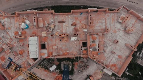 Construction of a multi-storey brick residential building of red color next to Stock Footage 126577822