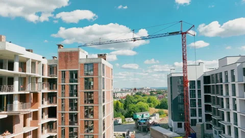 Construction of a multi-storey building. Aerial flying over an unfinished red Stock Footage 247327053