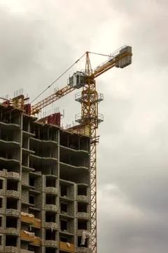 Construction of a multi-storey building with a construction crane Stock Photos