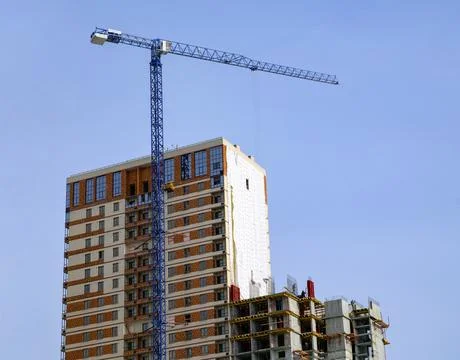 Construction of a multi-storey building. Construction crane and house Stock Photos