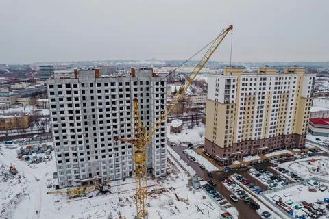 Construction of a multi-storey building with cranes and builders top view Stock Photos