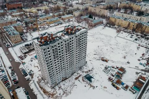 Construction of a multi-storey building with cranes and builders top view Stock Photos