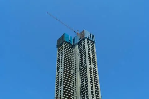 Construction of a multi-storey building. High-rise cranes. Stock Photos