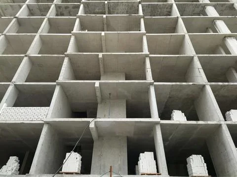 Construction of a multi-storey building made of concrete blocks and bricks Stock Photos