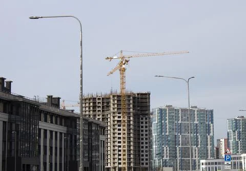 Construction of multi-storey buildings against the blue sky Stock Photos