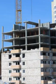 Construction of multi-storey monolithic house and industrial building crane Stock Photos