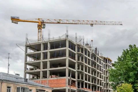 Construction of multi-storey monolithic house and industrial building crane i Stock Photos