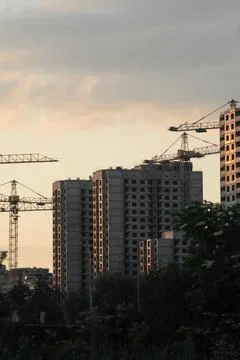 Construction of a multi-storey residential panel houses at sunset. Stock Photos