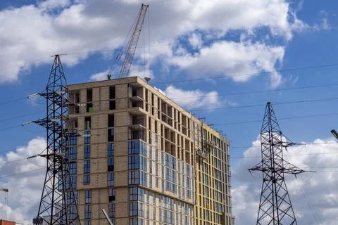 Construction of a Multi-Story Building Under a Blue Sky With Clouds and Pow.. Stock Photos