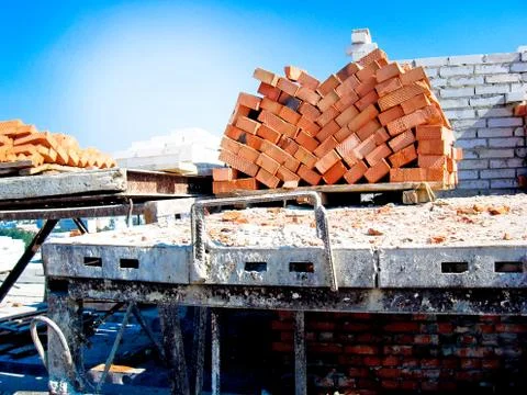 Construction of a multistory building. Brick and walls and ceilings of the un Stock Photos
