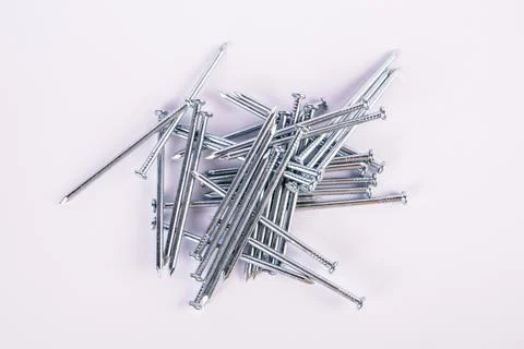Construction nails in a pile on a white background Stock Photos