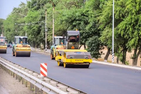 Construction of a new asphalt track. The rollers ram the asphalt. Road repair Stock Photos