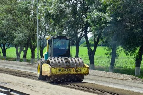 Construction of a new asphalt track. The rollers ram the asphalt. Road repair Stock Photos