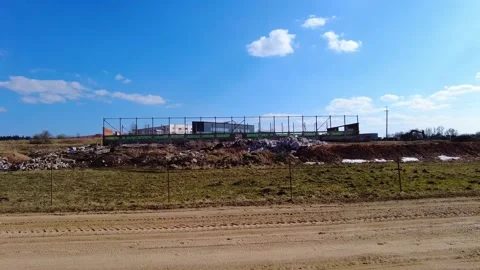 Construction of new building in open field near rural area during sunny day Stock Footage 333441908