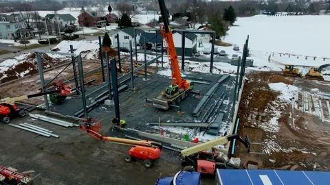 Construction of a New Building Site in Winter With Cranes and Workers Busy .. Stock Footage 335652249