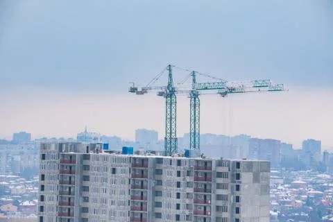 Construction of the new building. Two cranes in winter Stock Photos