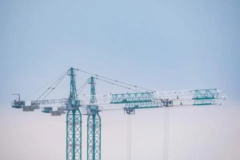 Construction of the new building. Two cranes in winter Stock Photos