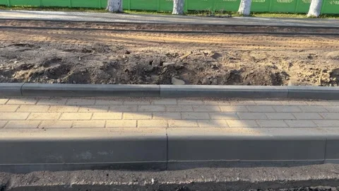 Construction of a new concrete curb and paving stone sidewalk is underway Stock-Footage 334067979
