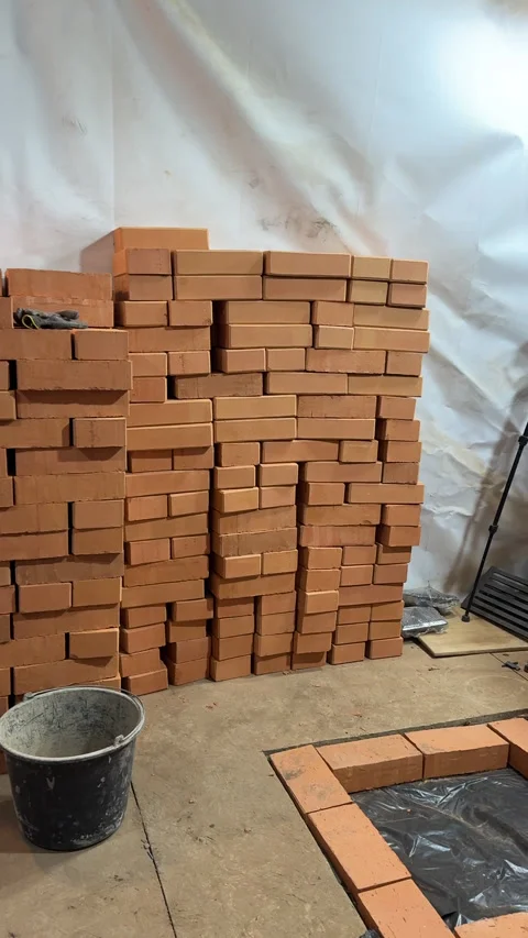 Construction of a new heating stove. A stack of bricks. On the foundation, .. Stock Footage 327721066