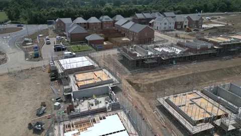 Construction of new homes in suburb with multiple building sites and progress Stock Footage 321256841