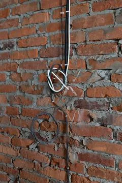 Construction of a new house, electrical cables twisted into a knot and fixed  Stock Photos