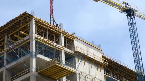 Construction of a new modern residential complex. Workers pour concrete. Stock Footage 235043841
