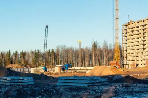 Construction of a new multi-storey building surrounded by forests. Constructi Stock Photos