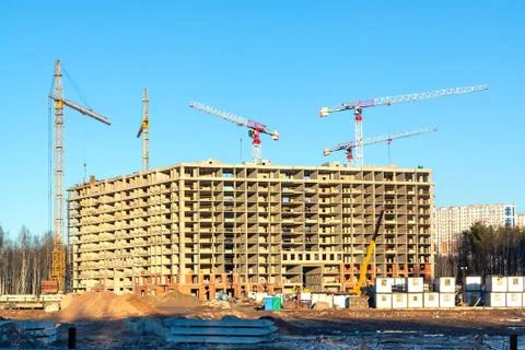 Construction of a new multi-storey building surrounded by forests. Constructi Stock Photos