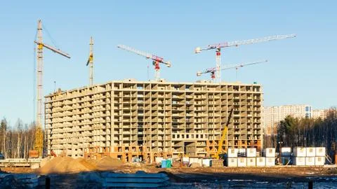 Construction of a new multi-storey building surrounded by forests. Constructi Stock Photos