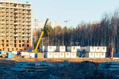 Construction of a new multi-storey building surrounded by forests. Constructi Stock Photos