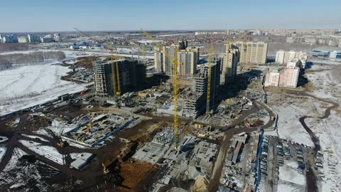 Construction of a new residential area in front of road traffic covered in snow. Stock Footage 94184073
