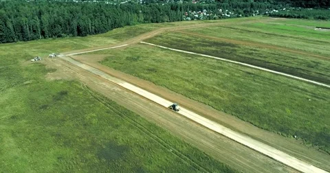 Construction of a new road in the middle of a field Stock Footage 79928568