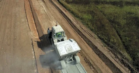 Construction of a new road in the middle of a field Stock Footage 79929533