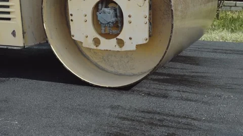 Construction of a new road. The roller levels and compacts the asphalt. Stock Footage 137662274