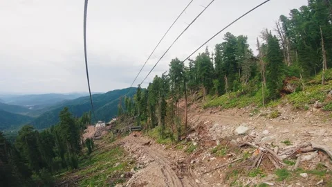 Construction of a new ski slope in the summer. view from a chairlift cabin in Stock Footage 270046820
