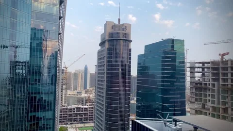 Construction next to modern towers 스톡 동영상 245852792