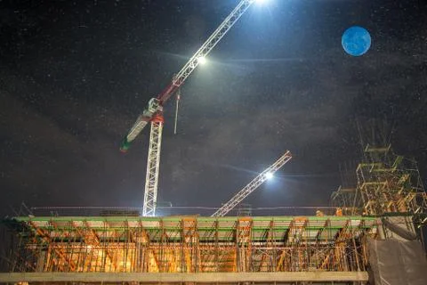 Construction at night with lights against the dark sky Stock Photos